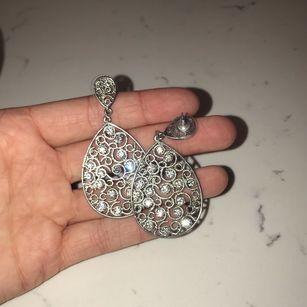 Women’s silver and diamond drop earrings.